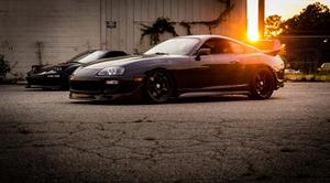 Sleek Toyota Supra parked on city street at night supra wallpaper