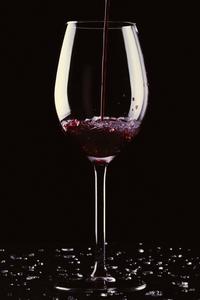 Enjoy a glass of wine while looking out into the darkness black screen wallpaper
