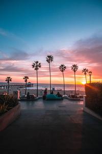 Enjoy the beauty of a beach sunset in this tranquil wallpapers lock screen wallpaper