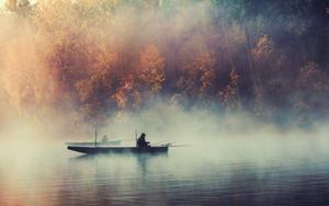 Enjoying an Early Morning Fishing Trip in a Misty Lake fishing wallpaper
