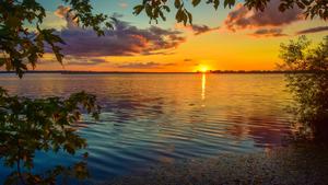Enjoying the stillness of a peaceful lake sunset 8k wallpaper