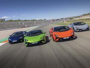 four lamborghinis are driving on a track lamborghini wallpaper