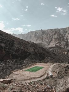 From high atop the mountain range, get a glimpse of a football stadium below football wallpaper