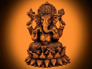 ganesha statue on an orange background ganesh wallpaper