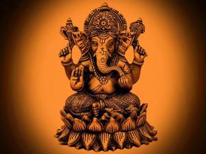 ganesha statue on an orange background ganesh wallpaper