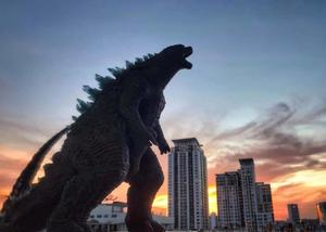 Godzilla Above Buildings During Sunset Picture godzilla wallpaper