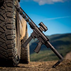 Gun Leaning On Tire gun wallpaper
