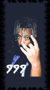 Juice Wrld performing in front of a neon-painted wall juice wrld wallpaper
