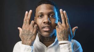 Lil Durk posing in a stylish outfit on a city rooftop lil durk wallpaper