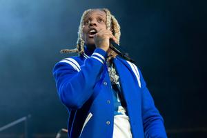 Lil Durk striking a pose in a stylish outfit lil durk wallpaper