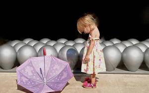 Little girl enjoying a day out in the rain girl wallpaper