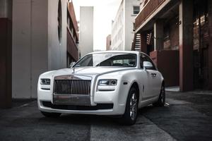 Luxurious Rolls Royce parked amidst an enchanting natural landscape. rolls royce wallpaper