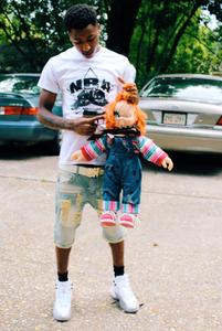 Nba Youngboy poses with signature Chucky doll nba youngboy wallpaper