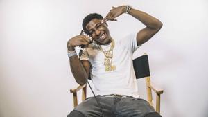 “NBA Youngboy sits in a director's chair on set" nba youngboy wallpaper