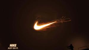 nike logo in the dark with a person standing on top of it