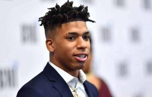 NLE Choppa in a dynamic pose during a photoshoot nle choppa wallpaper