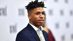 NLE Choppa poses in a stylish outfit during a photoshoot nle choppa wallpaper