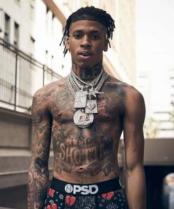 NLE Choppa posing for a portrait in a casual outfit nle choppa wallpaper