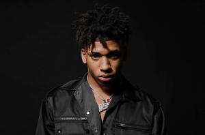 NLE Choppa striking a pose in an urban setting nle choppa wallpaper