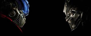 Optimus Prime and Megatron locked in epic battle dual monitor wallpaper