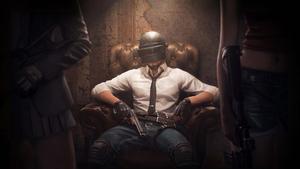 pubg mobile - a man sitting in a chair with guns pubg wallpaper