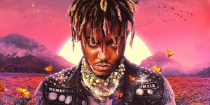 Rapper Juice Wrld performs on stage, wearing pink. juice wrld wallpaper