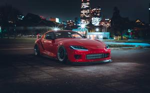 Red Toyota Supra Parked Near Cityscape toyota supra wallpaper