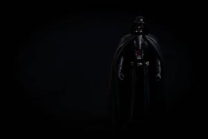 Sith Lord Darth Vader looms in the darkness Wallpaper
