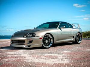 Sleek Toyota Supra sports car in a stunning scenic landscape supra wallpaper