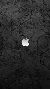 Strategically placed Apple logo against a cracked concrete backdrop. Wallpaper