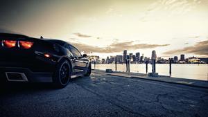 Stunning Red Sports Car on Night Road Wallpaper