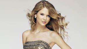 Taylor Swift exudes confidence and poise in a glittery blue dress taylor swift wallpaper
