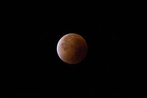 The glowing light of a full moon illuminates the night sky moon wallpaper