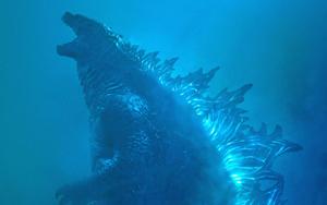 The King of Monsters, Godzilla, strikes a fierce pose looming over Tokyo. godzilla wallpaper