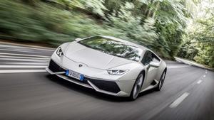 the lamborghini huracan is driving down a road lamborghini wallpaper
