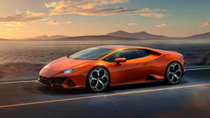 the orange lamborghini huracan is driving down the road lamborghini wallpaper