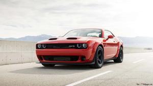the red dodge challenger is driving down the road dodge challenger 4k wallpaper