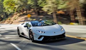 the white sports car is driving down a road lamborghini wallpaper