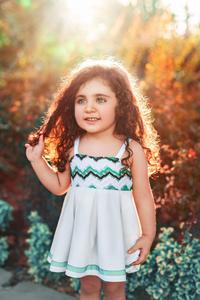 This beautiful curly-haired baby girl is ready to explore the world! girl wallpaper
