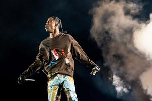 Travis Scott performing live on stage Wallpaper