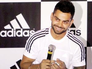 Virat Kohli Captivating the Crowd with his Signature Style  Wallpaper