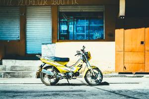 Yellow Motorcycle Near Store motorcycle wallpaper