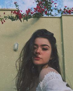 Young beautiful woman lounging in a flowers field. aesthetic girl wallpaper