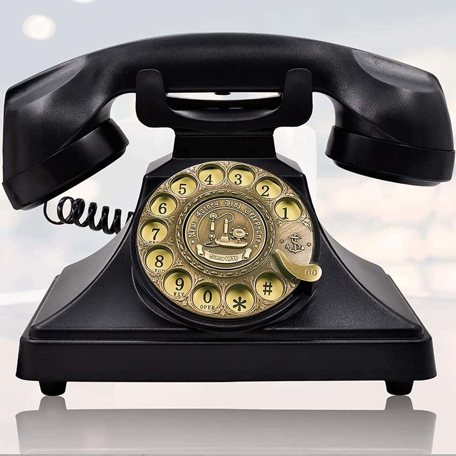 a black telephone with a gold dial — 1500x1500 wallpaper