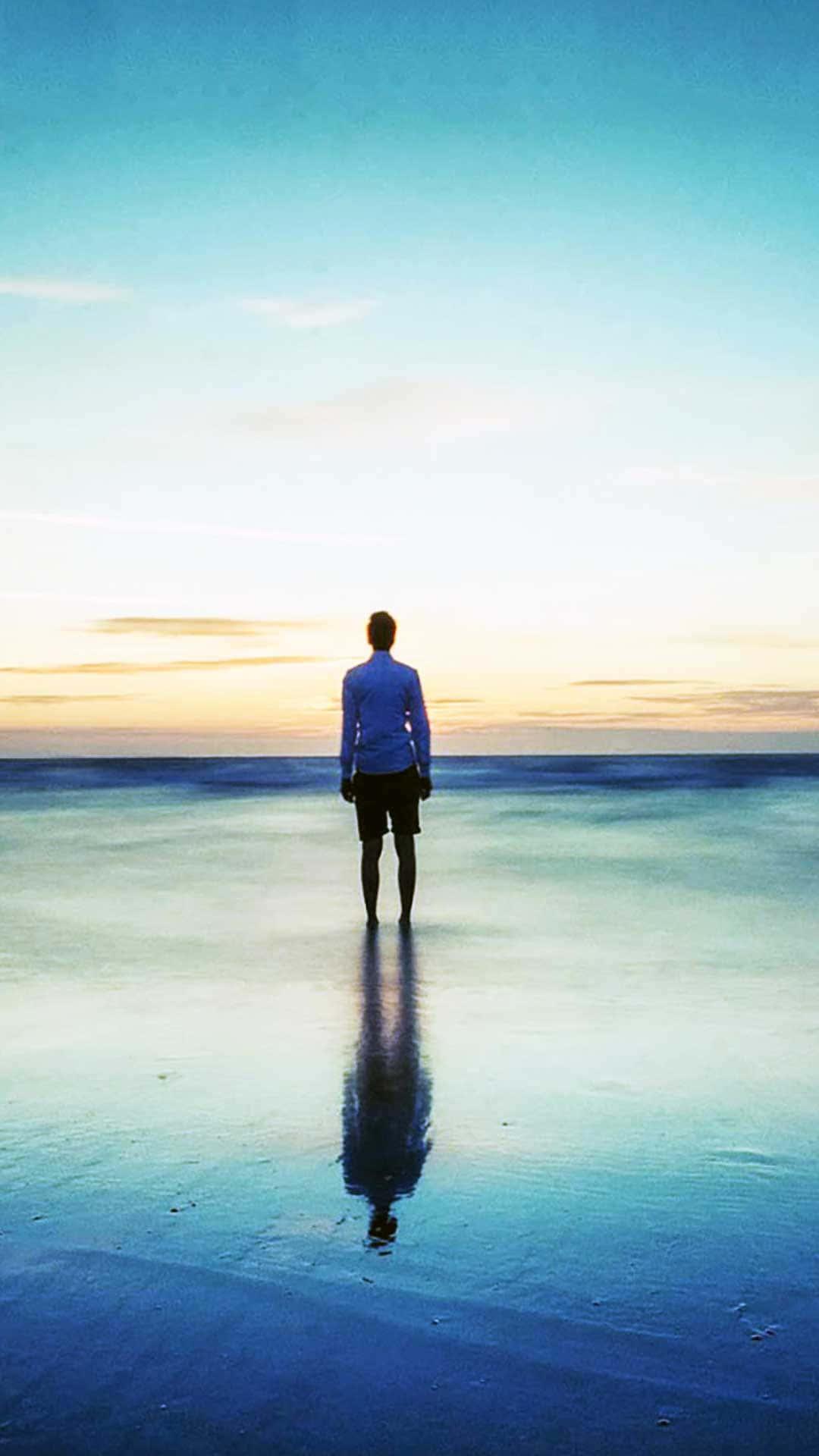 A boy looks intently at his phone, as if searching for something