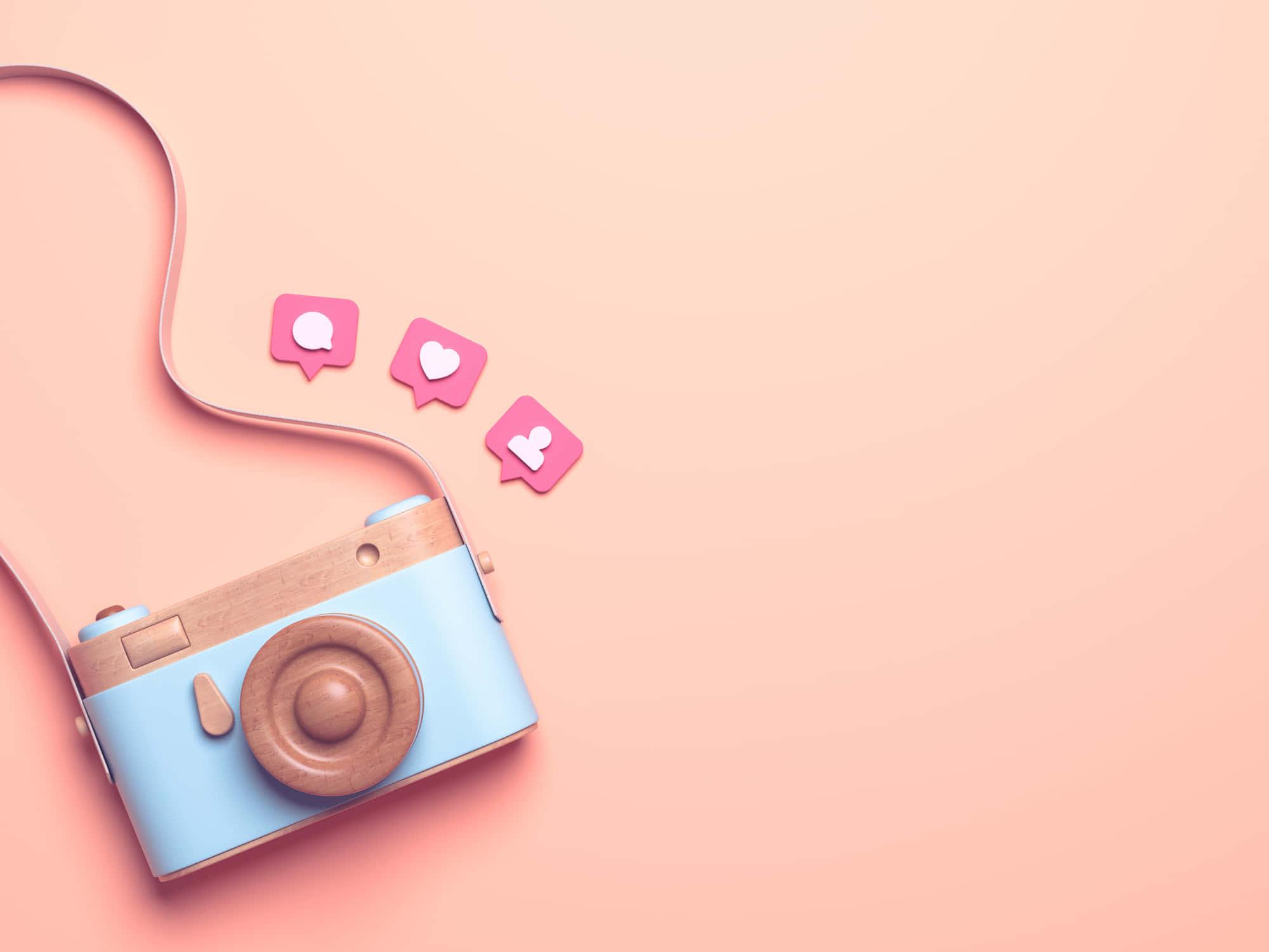 a camera with a pink background and text on it — 2000x1500 wallpaper