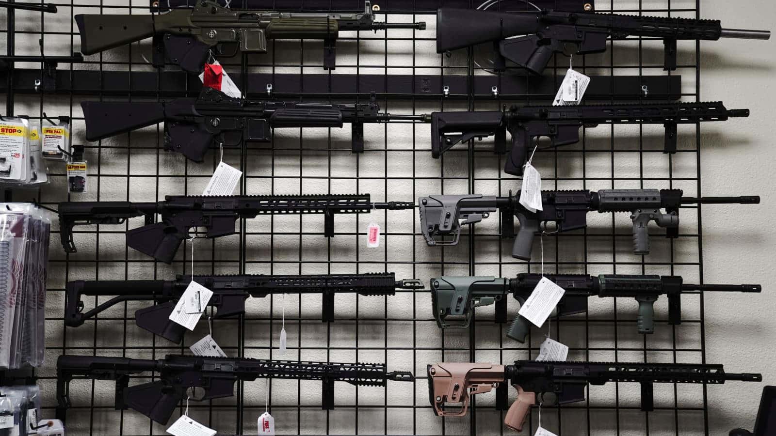 a display of guns on display in a store — 1600x900 wallpaper