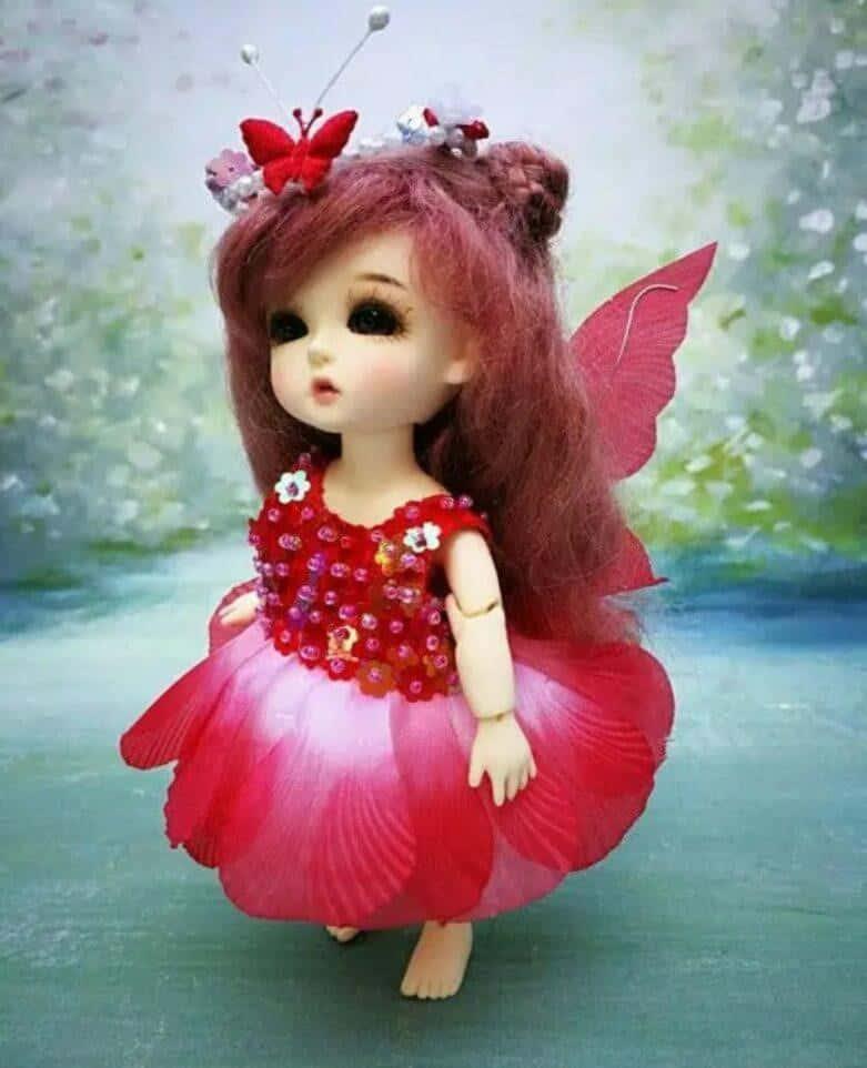 a doll with a red dress and butterfly wings — 781x962 wallpaper