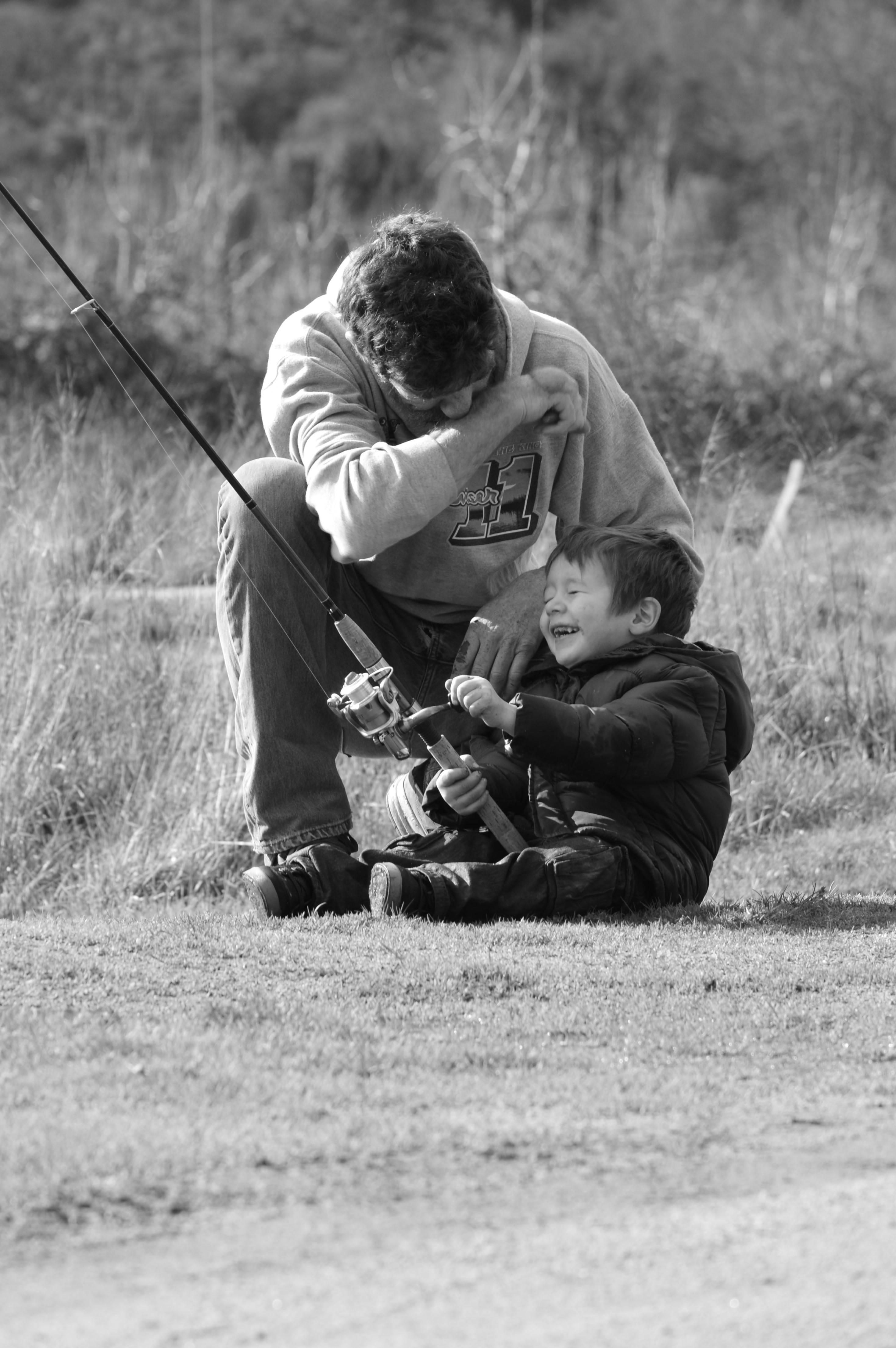 A father and son bonding over a shared fishing experience. — 2938x4418 wallpaper