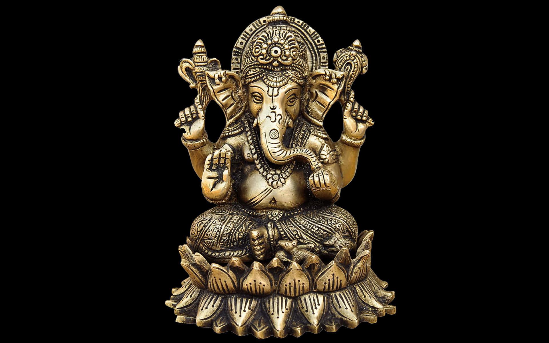 a gold ganesha statue on a black background — 1920x1200 wallpaper
